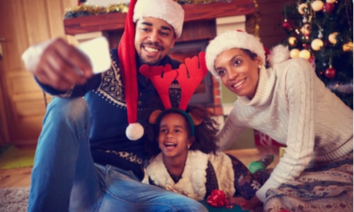 Family selfie in front of a Christmas tree